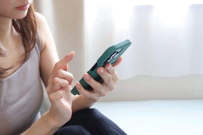 スマホで調べものをする女性