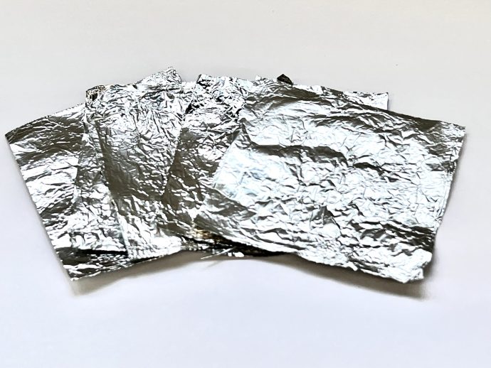 ジェルネイルオフのために小さくカットされたアルミホイルが並べて置かれている写真