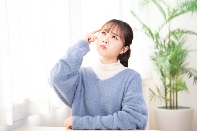 悩んでいる女性の写真