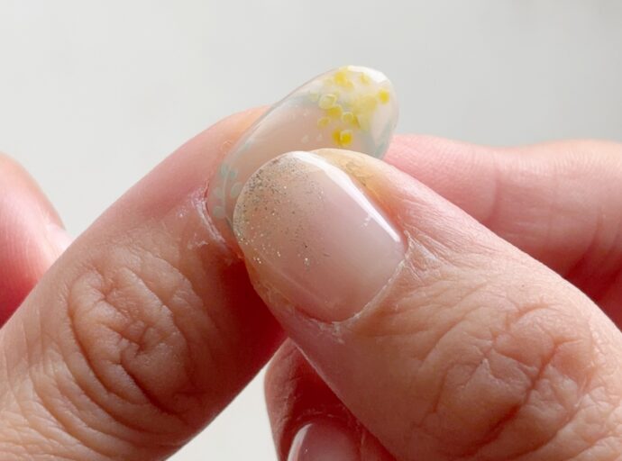 ネイルチップを爪に付けて押さえている様子