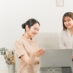 美容サロンスタッフとPCをチェックする様子